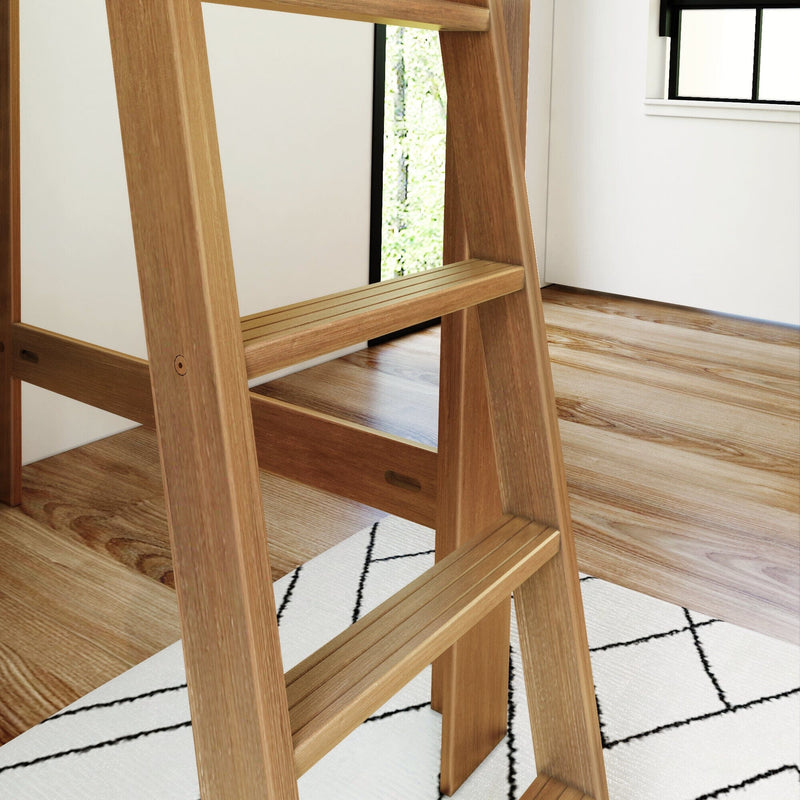Natural oak ladder shelf with slatted steps in a bright modern room on hardwood floor over a black-and-white geometric rug