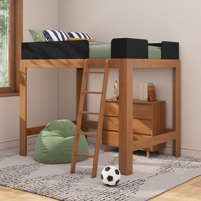 Wooden loft bed with ladder and black guardrails, green bedding and navy striped pillows in a modern kids' bedroom with bean bag, soccer ball and under-bed dresser