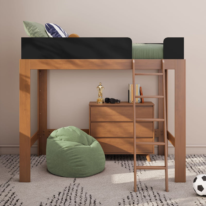 Modern wooden loft bed for kids with ladder and black guardrail, green bedding, bean bag and dresser in styled children's bedroom