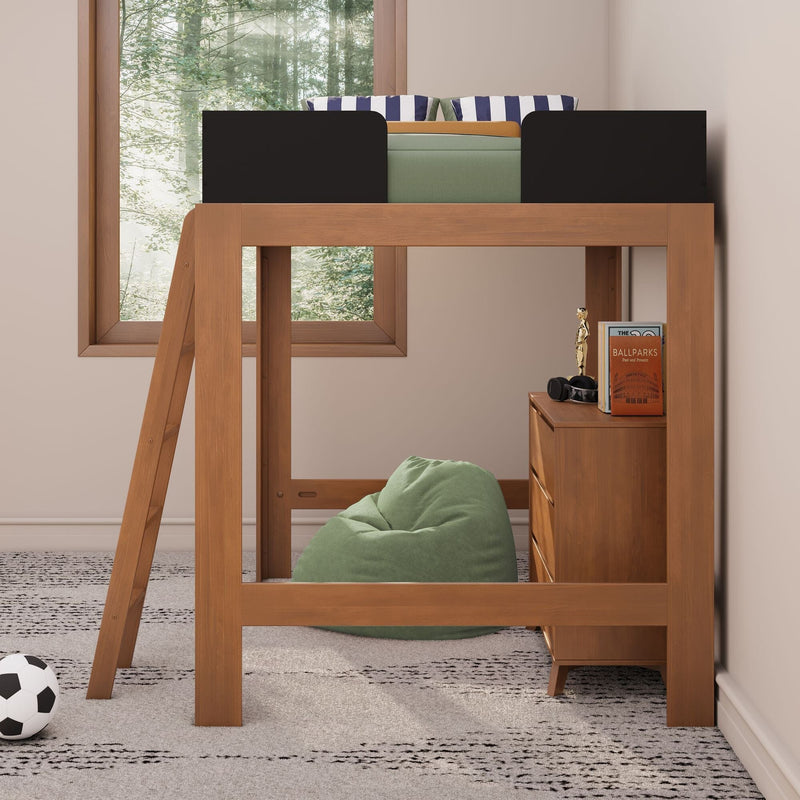 Wooden kids loft bed with ladder, green bean bag, striped pillows, bedside dresser and soccer ball under a forest-view window