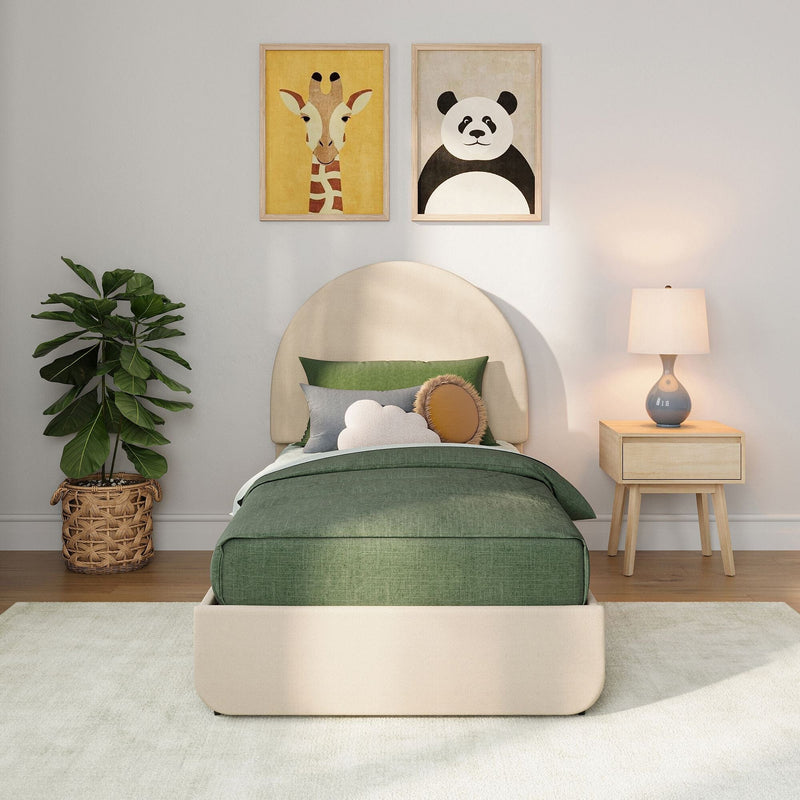 Children's bedroom with green bedding and rounded beige headboard, giraffe and panda framed animal wall art, wooden nightstand lamp and potted fiddle‑leaf fig — modern nursery decor