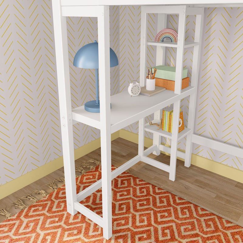 White corner shelving desk with blue lamp, clock, pencils, storage boxes and rainbow toy against chevron wallpaper and orange rug