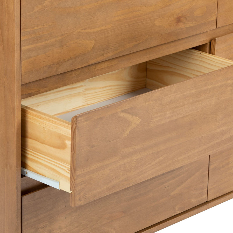 Close-up of wooden dresser with partially open drawer showing light natural wood interior, warm wood grain finish and white drawer slides, bedroom storage furniture