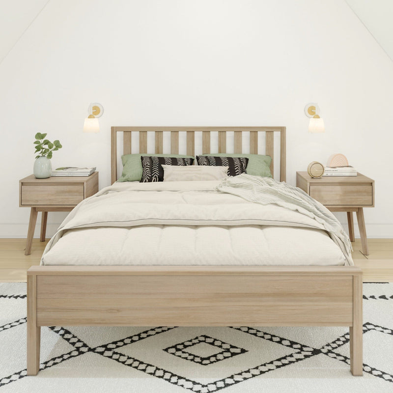 Minimal Scandinavian bedroom with light wood slatted bed frame, neutral linen bedding, green accent pillows, matching nightstands, wall sconces and geometric rug
