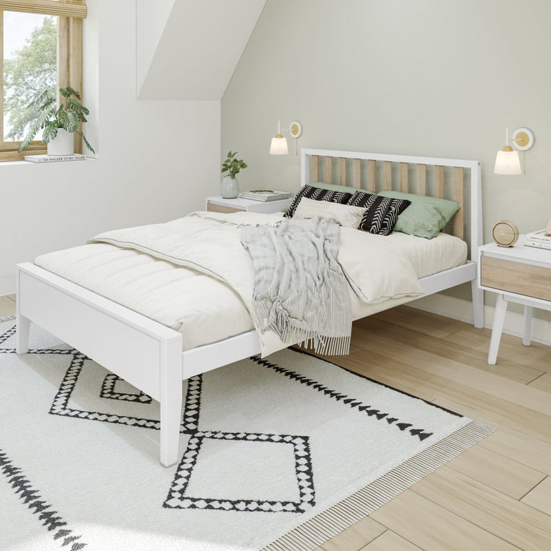 Minimalist modern bedroom with white wooden bed frame, light green accent wall, cozy layered bedding, black geometric rug, bedside tables and wall sconces