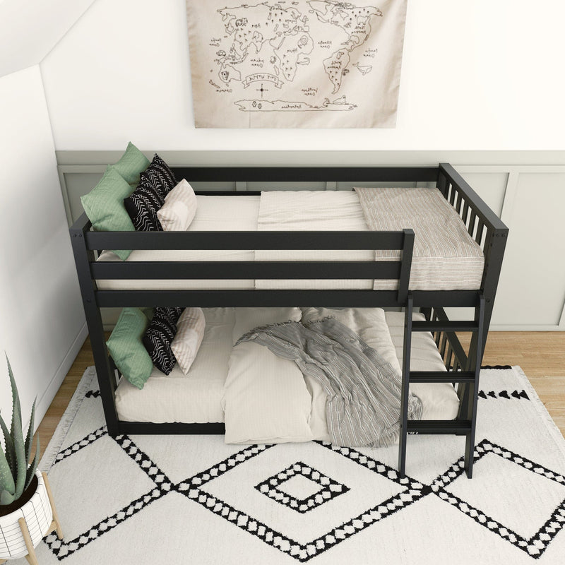 Modern kids' bedroom with black metal bunk bed, neutral linen bedding and green accent pillows on a boho black-and-white geometric rug, potted aloe plant and framed world map wall art
