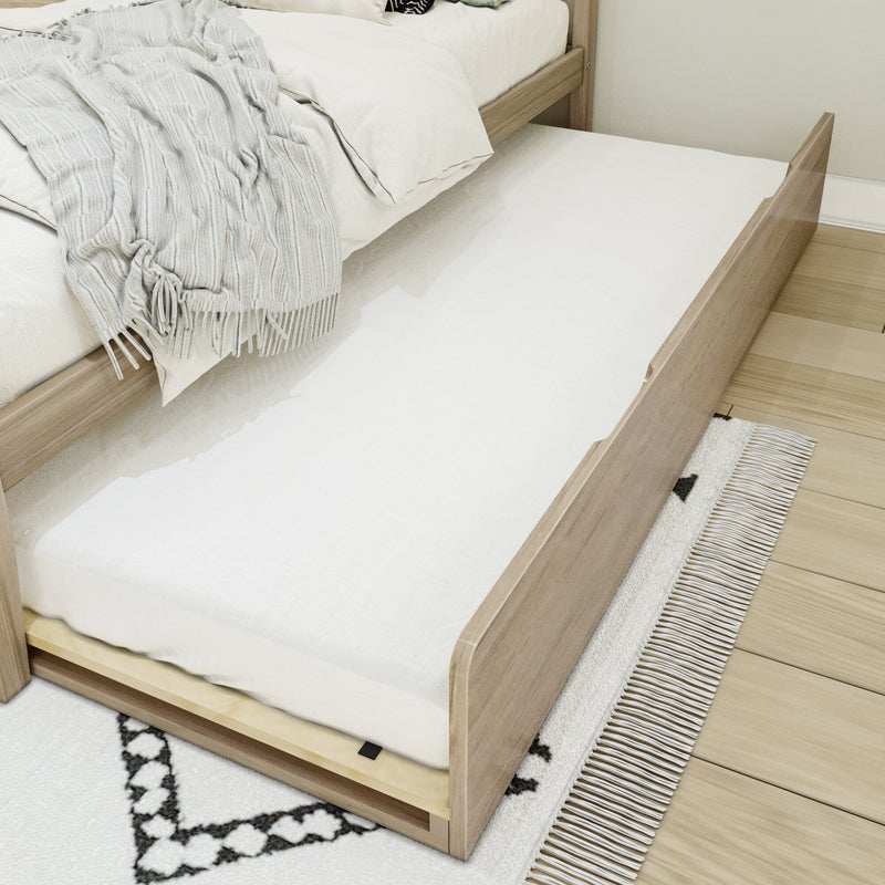 Wooden trundle bed with white bedding and pull-out mattress, light gray throw blanket and textured fringe rug in a modern minimalist bedroom