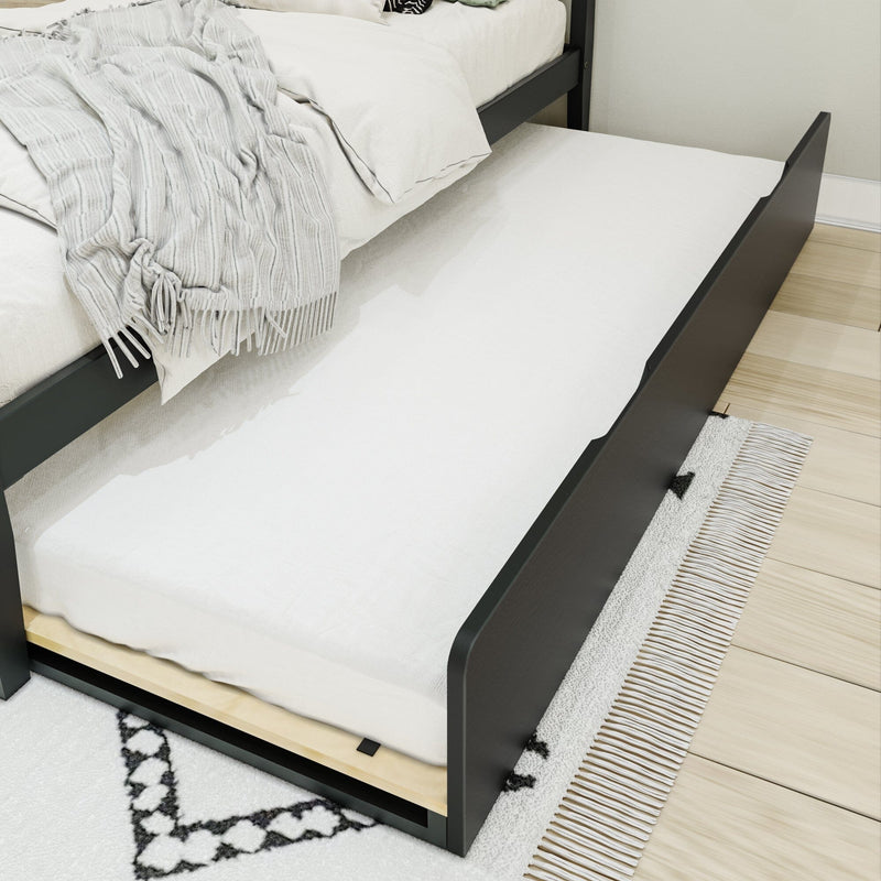 Space-saving dark wood trundle bed with white bedding and gray textured throw blanket, pull-out mattress on hardwood floor
