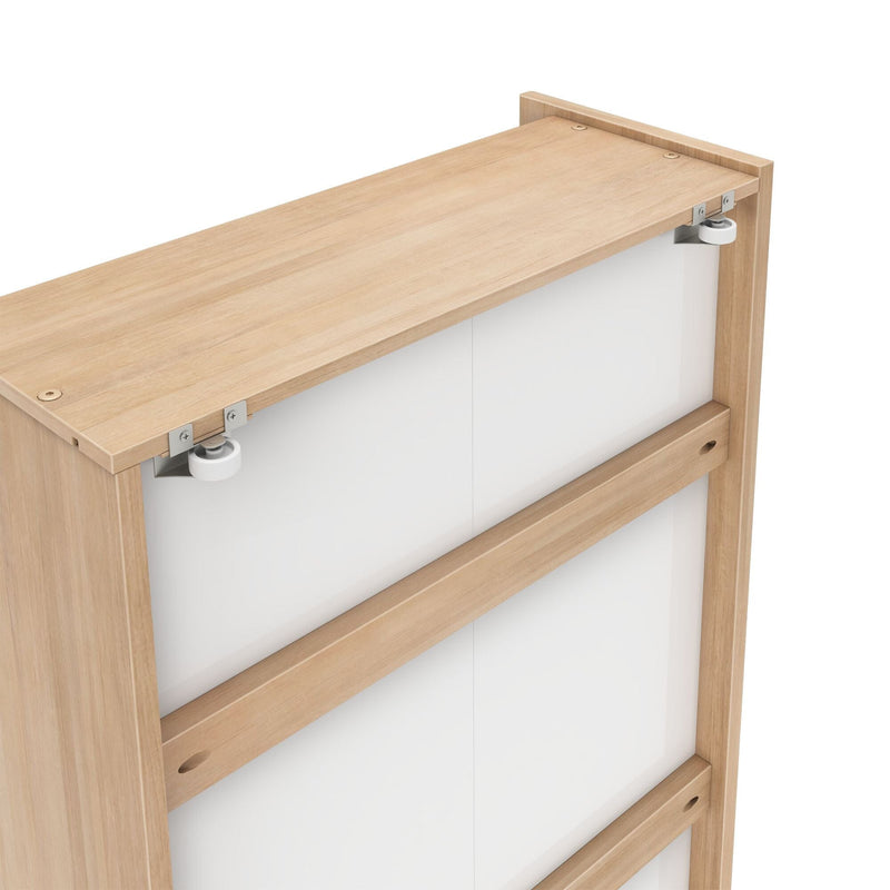 Sliding door hardware on light oak cabinet top with exposed metal roller wheels and white panel sliding doors