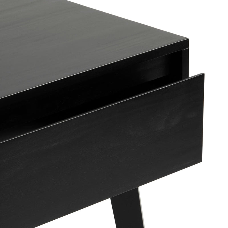 Close-up of a black wooden nightstand with an open drawer and tapered leg, modern minimalist bedside table with matte finish