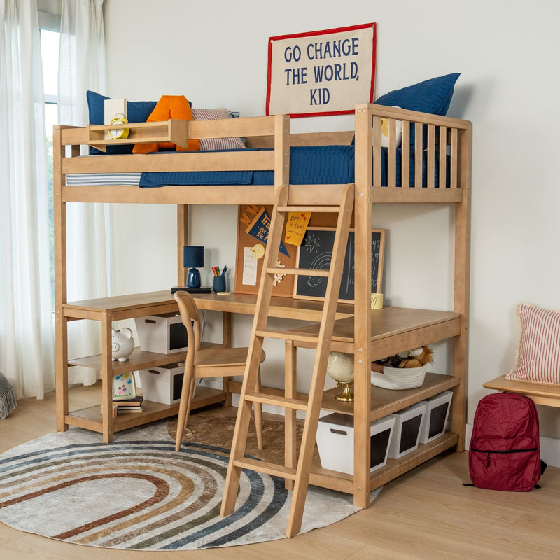 Modern wooden kids loft bed with ladder, built-in desk and storage bins in a children's bedroom with blue bedding, circular rug and motivational wall banner