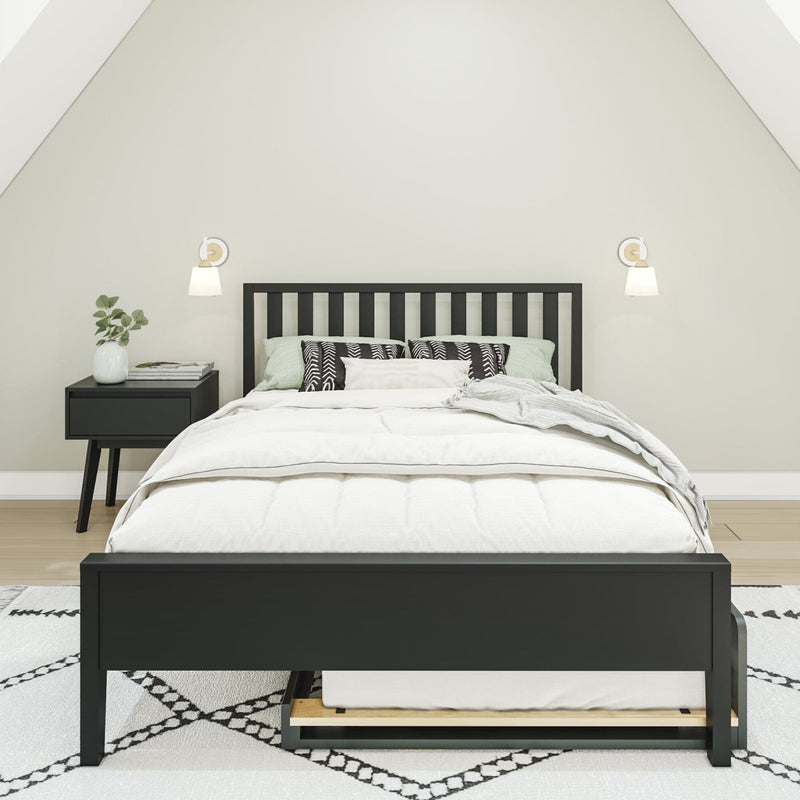 Minimalist bedroom with black wooden bed frame, white bedding, patterned pillows, nightstand with plant and wall sconces