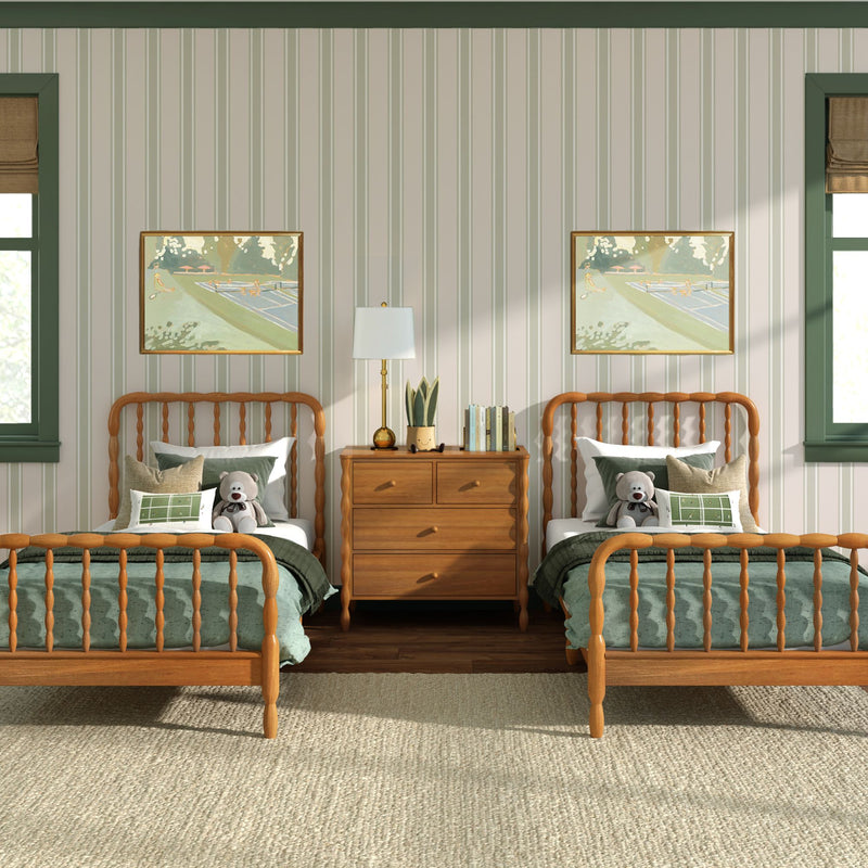 Cozy kids' bedroom interior with matching wooden spindle twin beds, green bedding and pillows, stuffed teddy bears, striped wallpaper, framed artwork and a wooden nightstand with lamp and plant