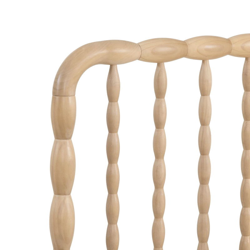 Close-up of light maple wooden chair back with turned spindles and curved top rail, farmhouse Windsor-style chair detail