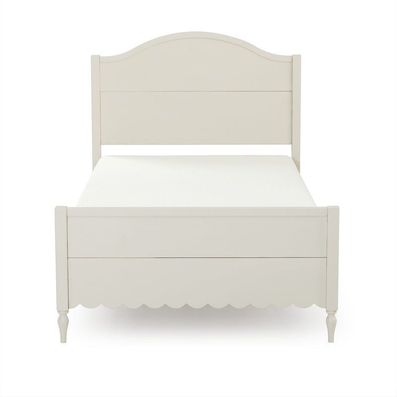 Off-white wooden twin bed frame with arched headboard, scalloped footboard, turned legs, farmhouse bedroom furniture