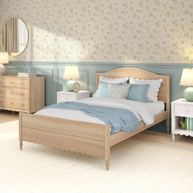 Cozy coastal farmhouse bedroom with light wood bed, blue bedding, floral wallpaper, matching nightstands and lamps
