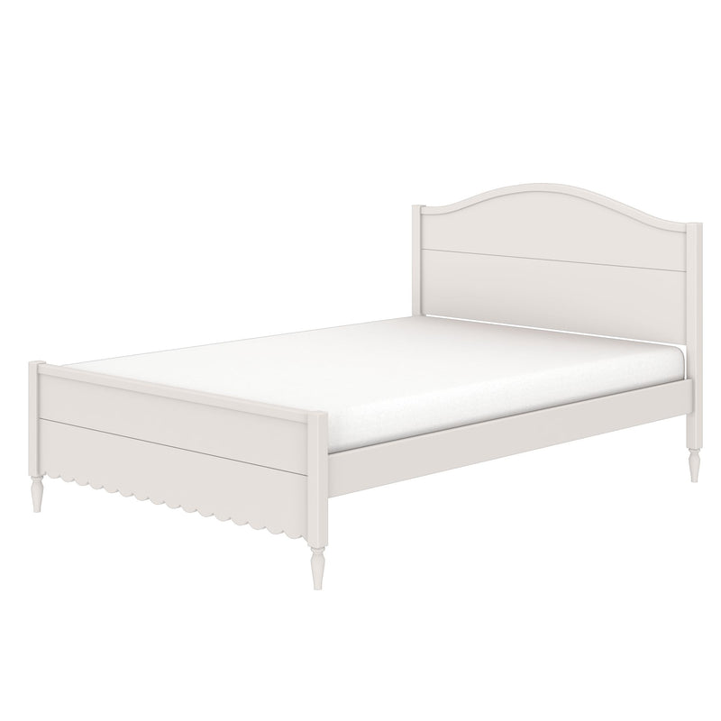 White farmhouse wooden bed frame with curved headboard, scalloped apron and turned legs