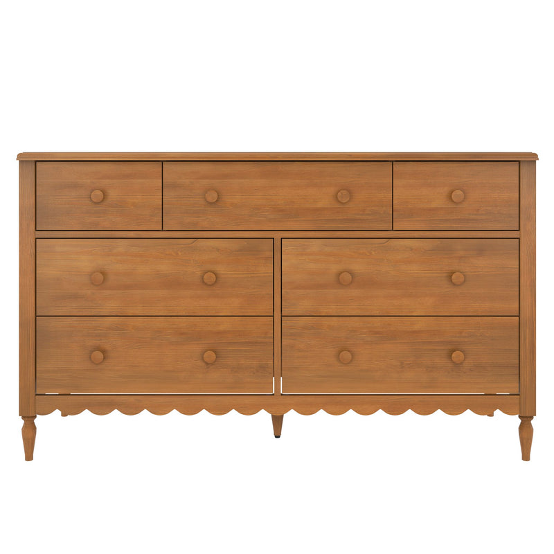 Mid-century wooden dresser in natural oak finish with multiple drawers, round wooden knobs, turned legs, and scalloped skirt
