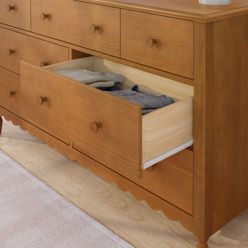Solid wood multi-drawer bedroom dresser with an open drawer revealing neatly folded clothes, maple finish dresser for bedroom storage