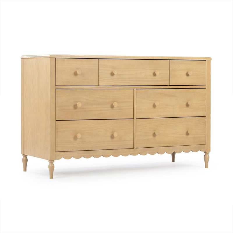 Light natural wood multi-drawer dresser with round wooden knobs, scalloped apron and turned legs — classic farmhouse bedroom chest of drawers