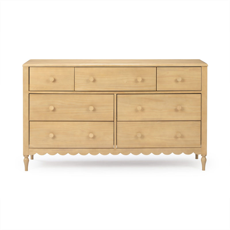 Light wood six-drawer dresser with round knobs, scalloped apron and turned legs, natural pine finish, bedroom storage.