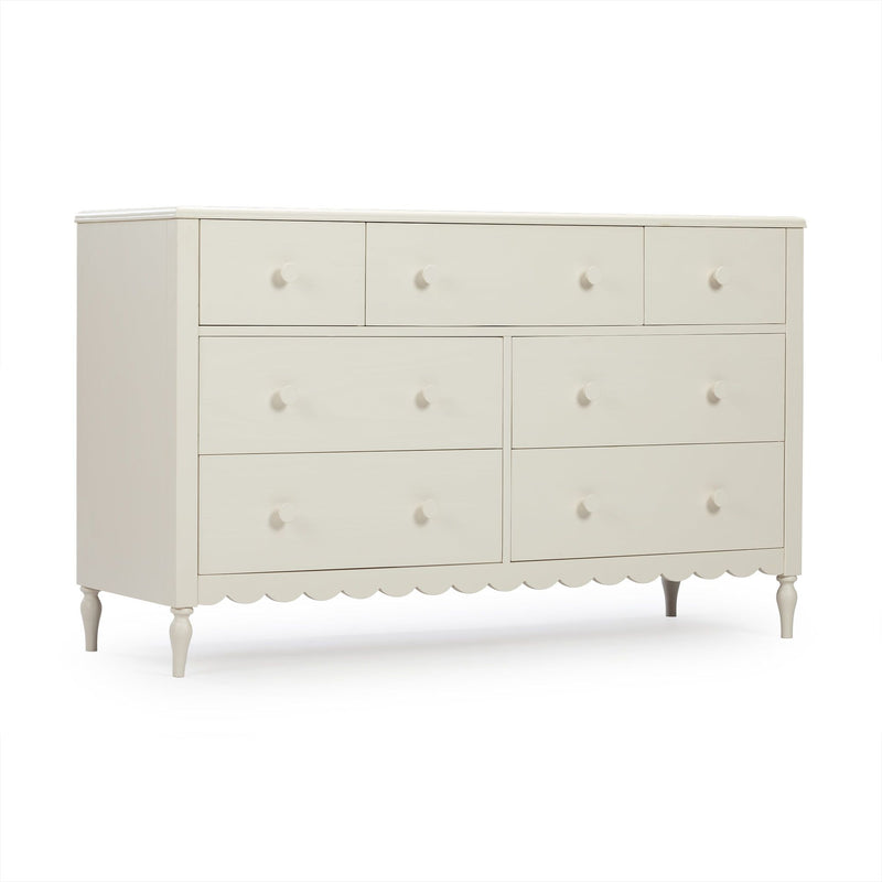 White wooden dresser with multiple drawers, round knobs, scalloped skirt and turned legs for bedroom or nursery storage