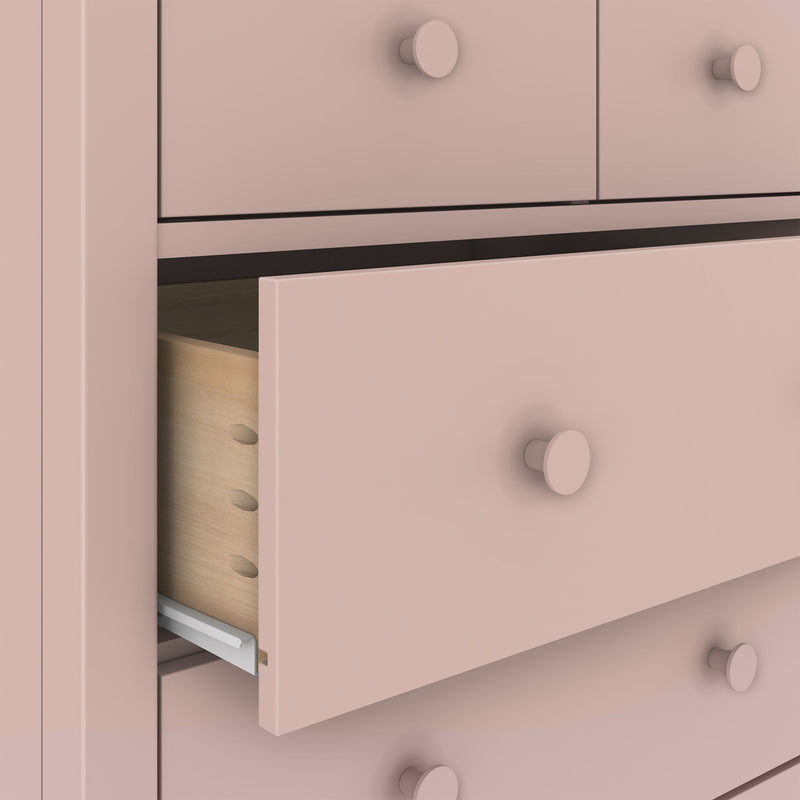 Pastel pink wooden dresser with an open drawer revealing natural pine interior, round knob pulls and scalloped base — stylish nursery or girls' bedroom storage chest