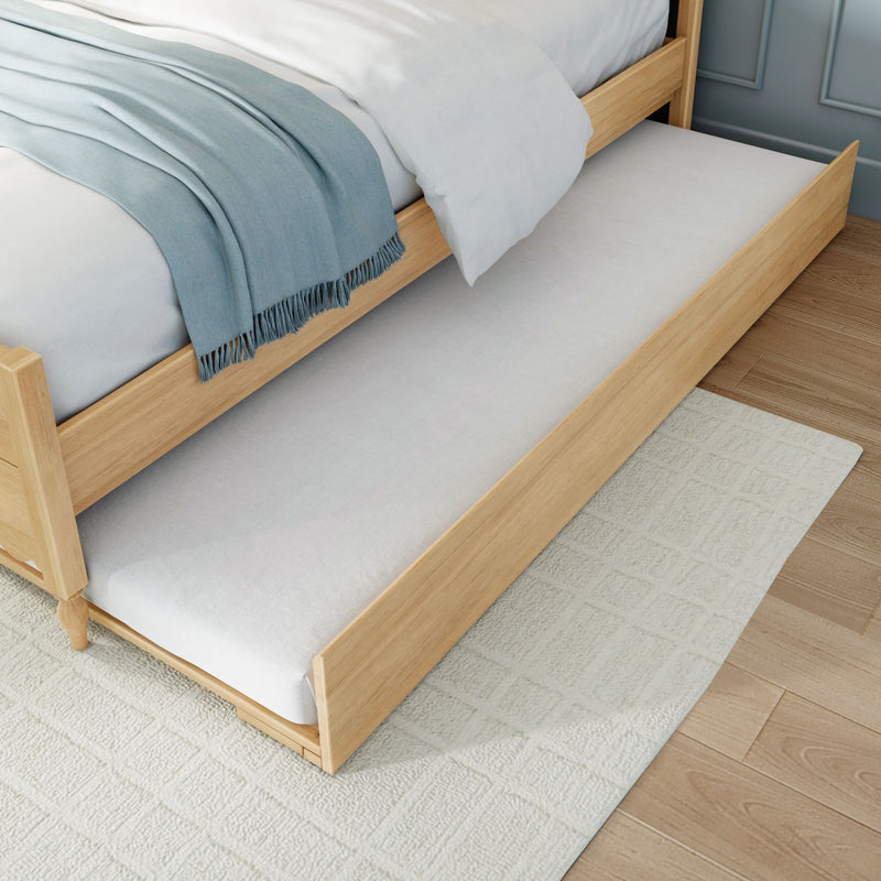 Wooden trundle bed with pull-out mattress, light oak frame, white bedding and blue throw — space-saving guest bed for small bedrooms