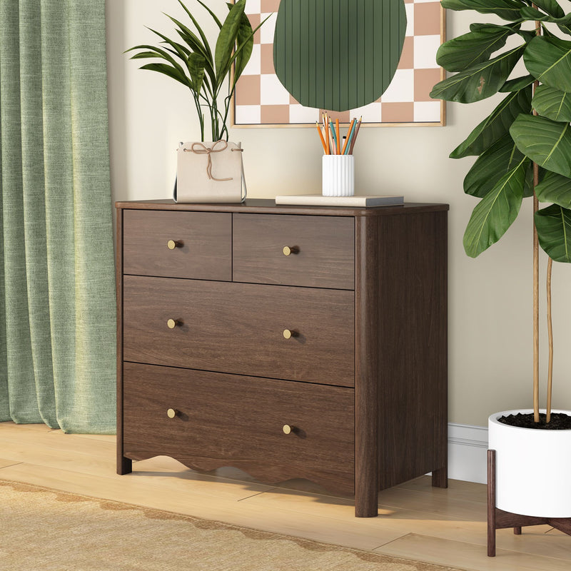 Dark walnut dresser with brass knobs in modern bedroom styling, green curtains, potted fiddle-leaf fig and pencil holder