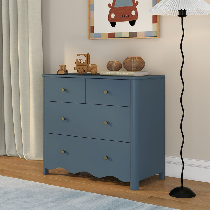 Blue nursery dresser with wooden toy trucks, wicker baskets, framed car print and floor lamp, modern kids room storage and decor