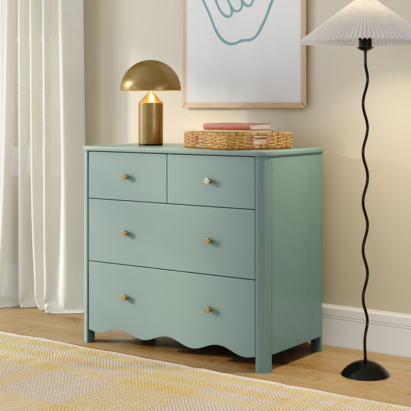 Mint green bedroom dresser with brass mushroom table lamp, woven storage basket and books, pleated floor lamp, neutral curtains