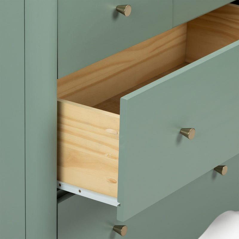 Close-up of mint green dresser with open wooden drawers and brass cone knobs, modern bedroom storage cabinet with painted finish