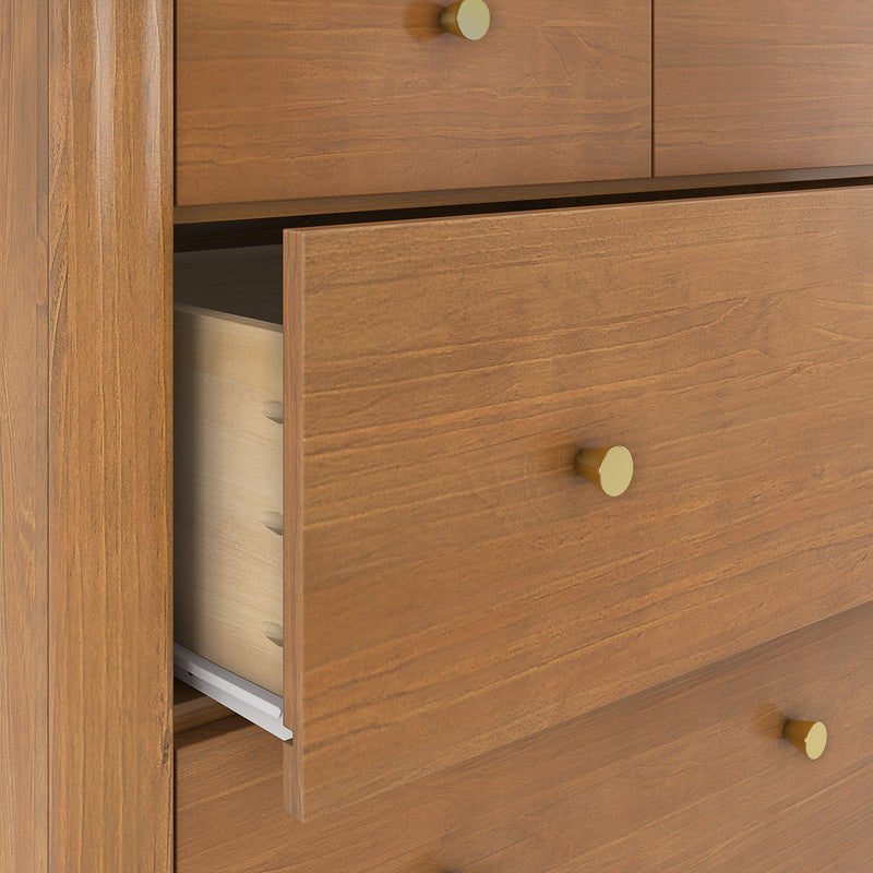 Close-up of solid wood dresser drawers with open drawer, brass round knobs, dovetail joints and warm wood-grain finish