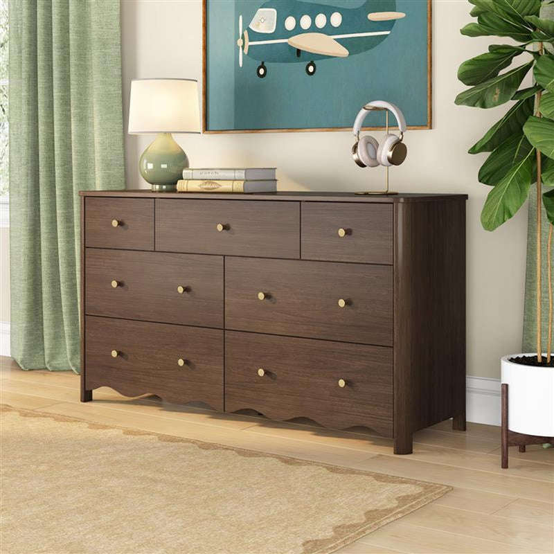 Mid-century modern 9-drawer walnut dresser with brass knobs in a styled bedroom for clothing storage