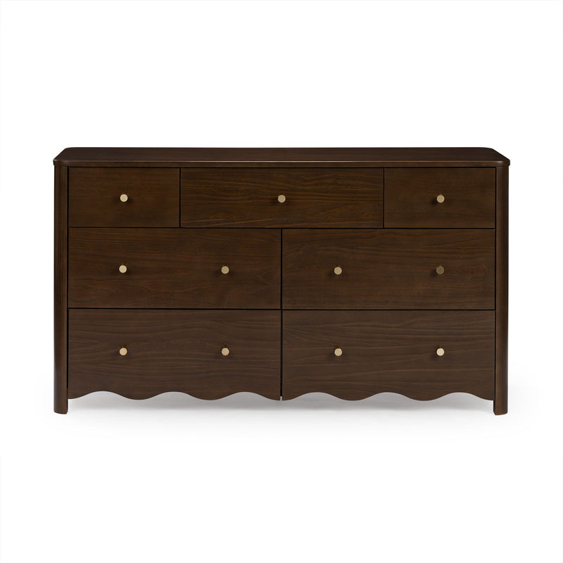 Dark walnut wooden dresser with multiple drawers, round brass knobs and scalloped apron base, bedroom storage chest