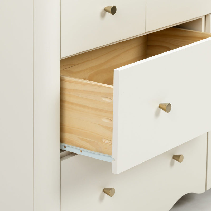 Minimalist white dresser with one open drawer showing natural wood interior and brass cone knobs, modern bedroom storage