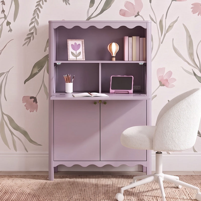 Pastel lavender kids desk cabinet with scalloped shelf, floral wallpaper backdrop, white boucle swivel chair and school supplies — girls' nursery study nook and storage solution