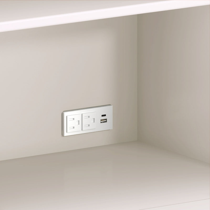 Modern white wall outlet with dual AC sockets and USB-A and USB-C ports installed above a beige kitchen countertop