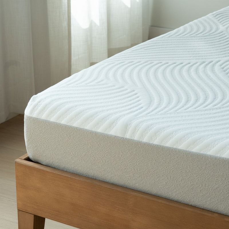 Close-up of white textured mattress with quilted cover on wooden bed frame in bright minimalist bedroom