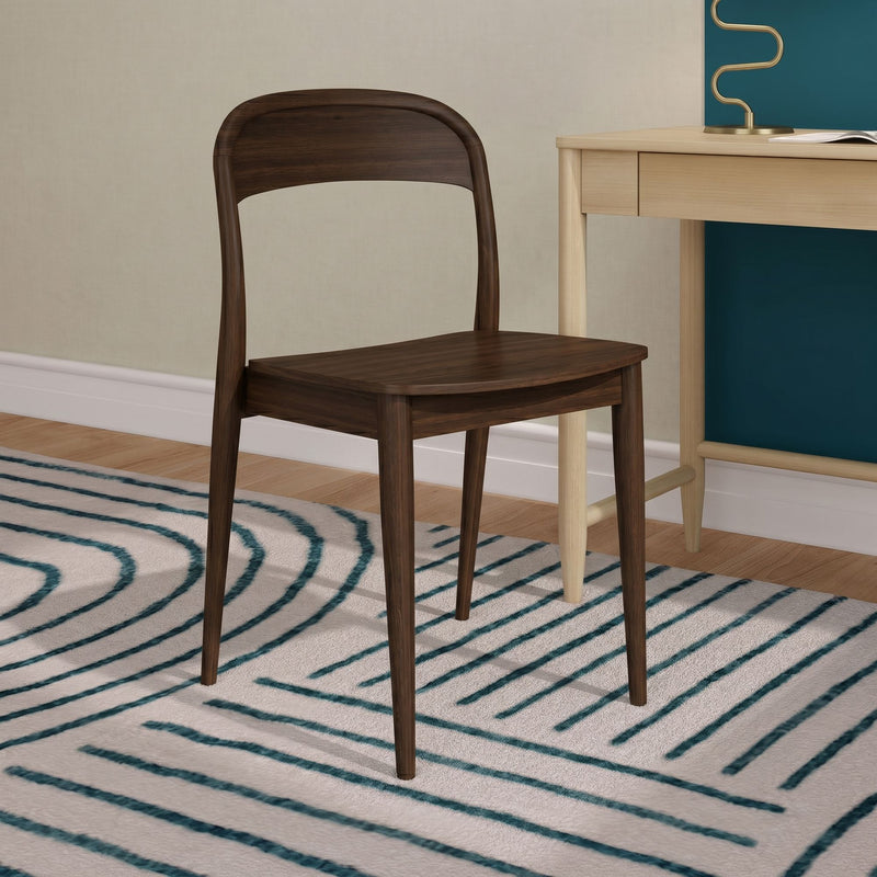 Walnut wooden chair beside light wood desk with teal accent wall and striped teal rug in modern minimalist home office