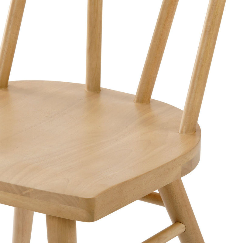 Close-up of light beech wood dining chair seat and spindle back with natural finish, solid wood Scandinavian-style chair
