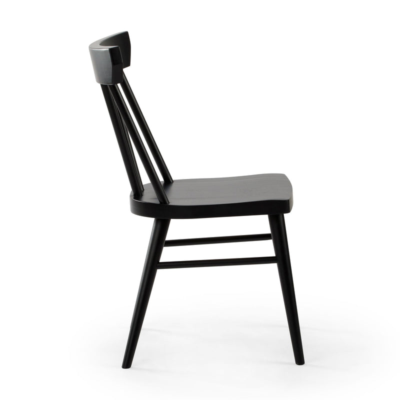 Side view of a black wooden spindle-back dining chair with matte finish, isolated on a white background.