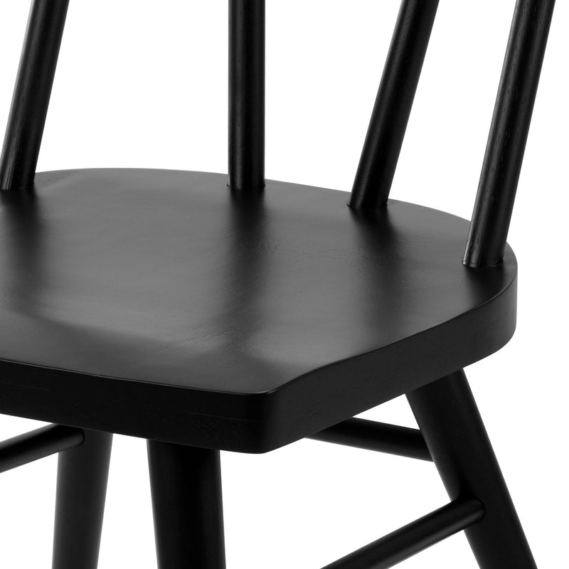 Close-up of black wooden dining chair seat and spindle back with matte painted finish