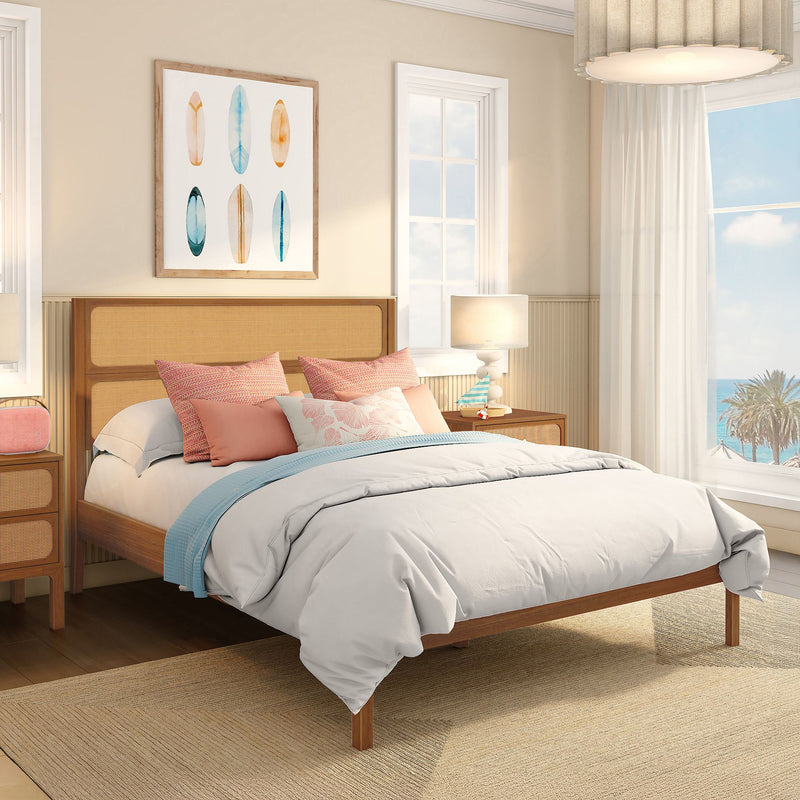 Coastal bedroom decor: light airy beach house bedroom with rattan headboard, coral and turquoise pillows, white bedding, surfboard wall art and ocean view