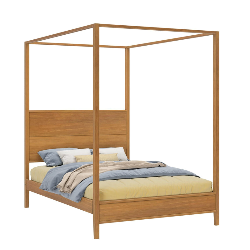 Minimalist natural wood four‑poster canopy bed frame with solid headboard, styled with blue and yellow bedding and throw pillows
