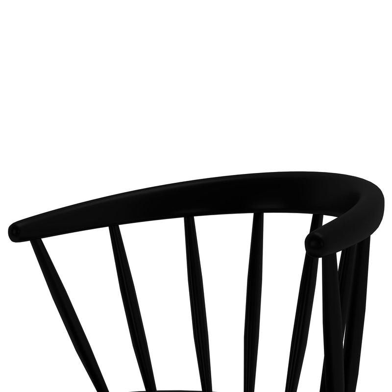 Close-up of black wooden dining chair back with curved top rail and vertical spindles on white background