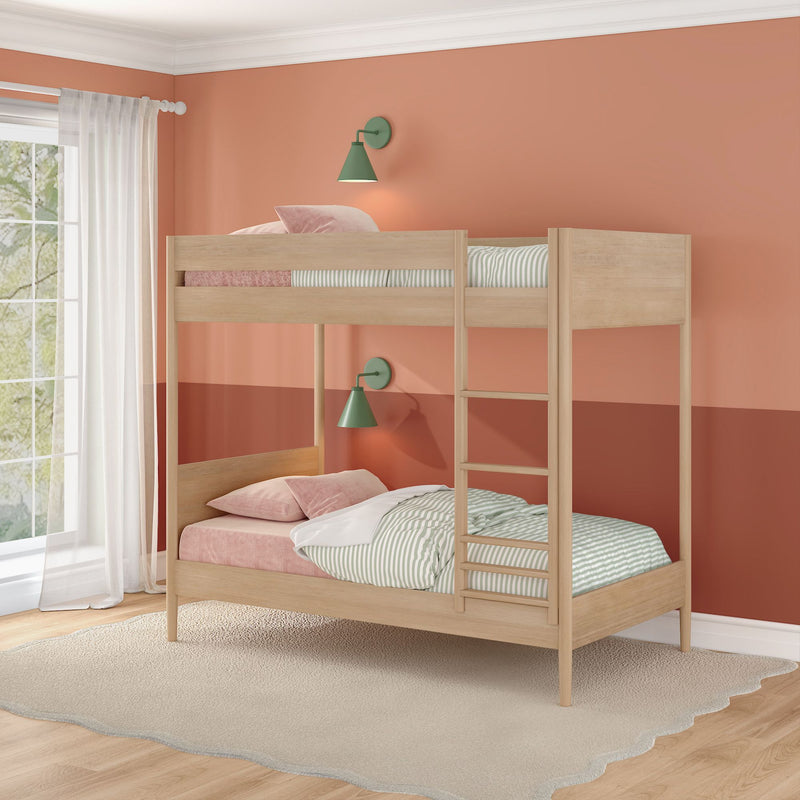 Light-wood bunk bed in a coral peach kids' bedroom with green wall sconces, striped bedding, pink pillows and sheer window curtains