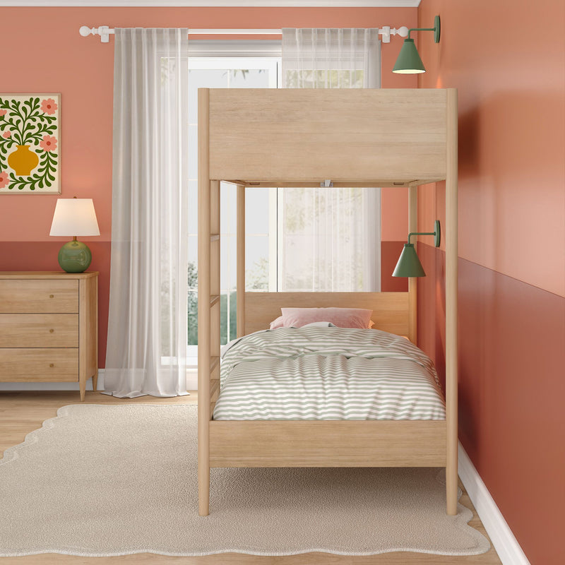 Modern kids' bedroom with natural wood bunk bed, coral painted walls, sheer curtains, striped bedding, green wall sconces and wooden dresser