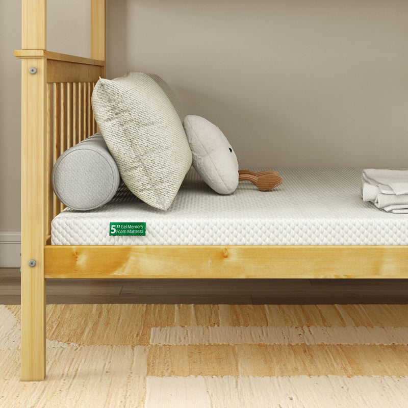 5-inch gel memory foam mattress with white textured cover on light wood bed frame, decorative pillows and folded sheets