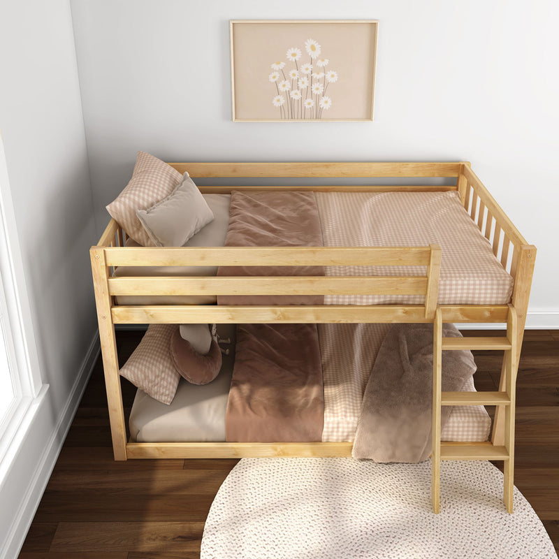 Natural wood twin-over-twin bunk bed with beige gingham and blush bedding, cozy kids' bedroom with daisy wall art and soft rug